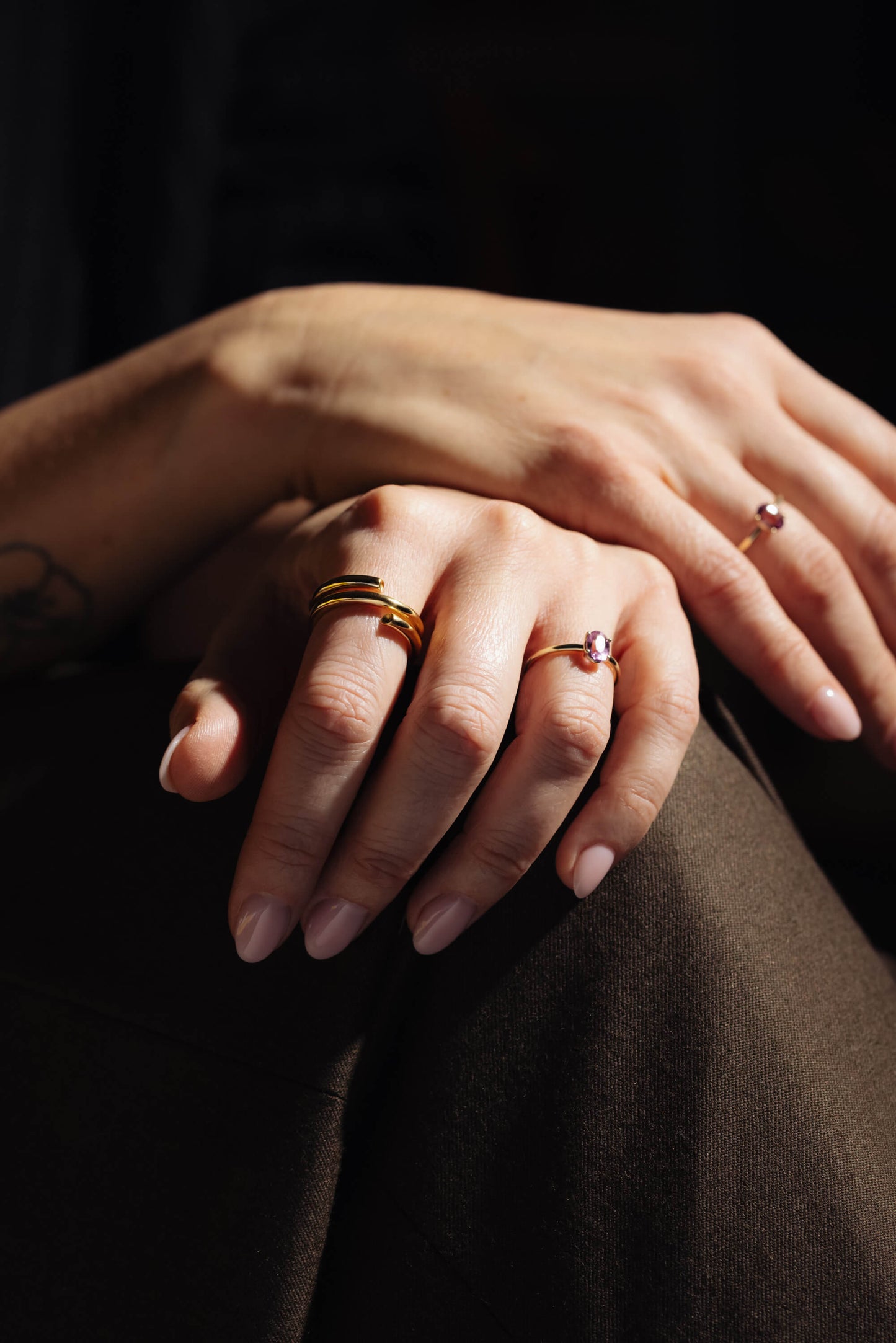 gold rings on hands pink stone